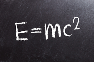 A chalkboard with the word e = mc 2 written in white chalk.