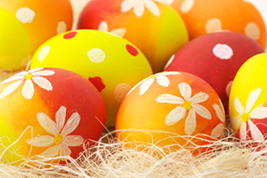 A close up of some decorated eggs in the hay